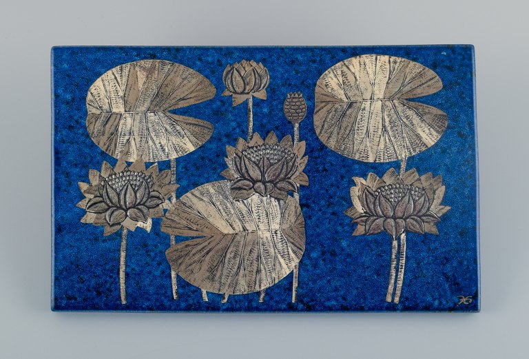 Heinz Erret (1920-2003) for Gustavsberg, "Vit näckros , Södermanland", wall 
plaque in glazed ceramic with silver inlay in the form of flowers.
