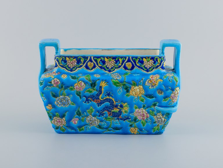 Longwy, France, large art deco jardiniere with handle, azure glaze decorated 
with flowers.