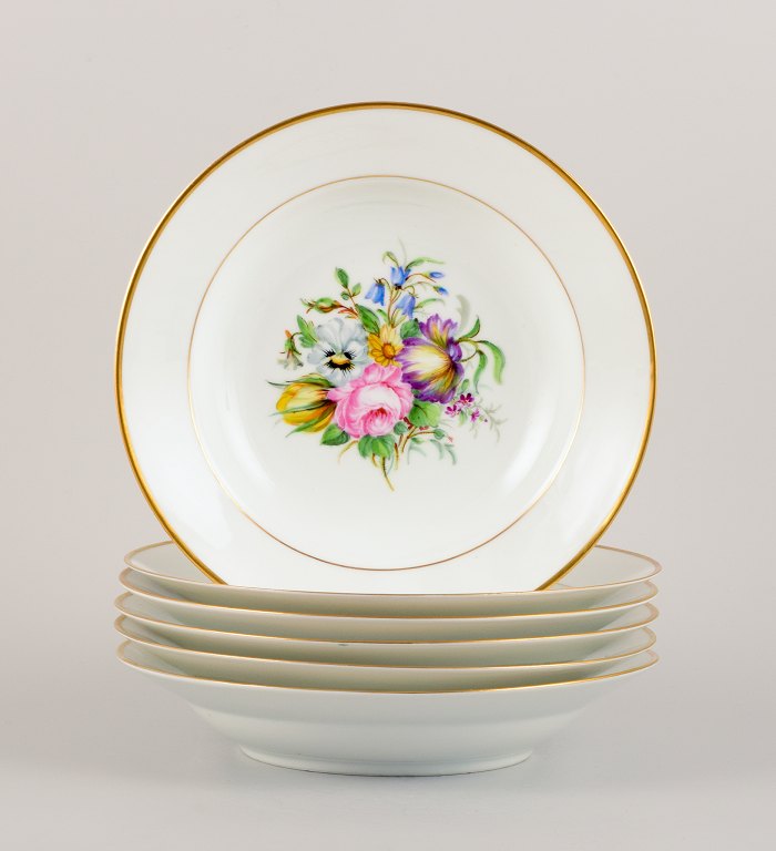 Bing & Grøndahl, six deep plates in porcelain hand-painted with polychrome 
flowers and gold decoration.