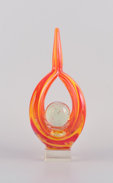 Murano, Italy, sculpture in hand-blown colored glass.
Modernist design. Art glass in yellow and orange, ball in clear glass with 
internal air bubbles.