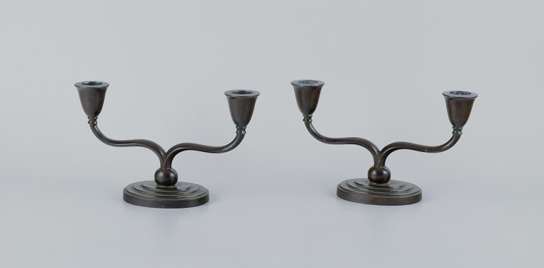 Just Andersen, a pair of Art Deco two-armed candlesticks in "disko" metal.