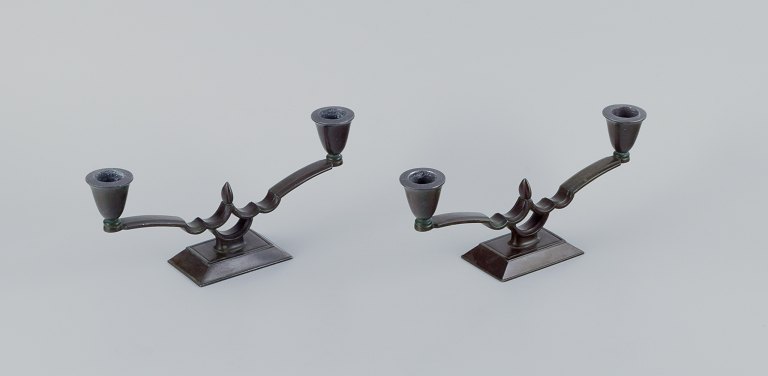 Just Andersen, a pair of two-armed Art Deco style candlesticks in "disko" metal.