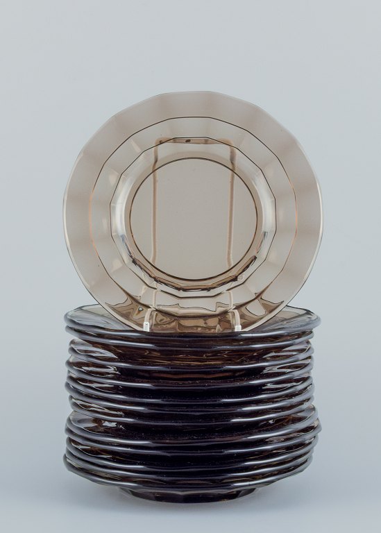 Simon Gate (1883-1945) for Orrefors/Sandvik, Sweden.
A set of thirteen small Art Deco plates in smoked coloured pressed glass.