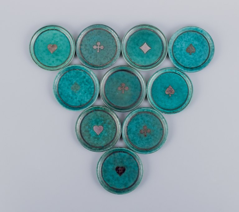 Wilhelm Kåge for Gustavsberg, Sweden. A set of ten "Argenta" coasters/bottle 
trays.