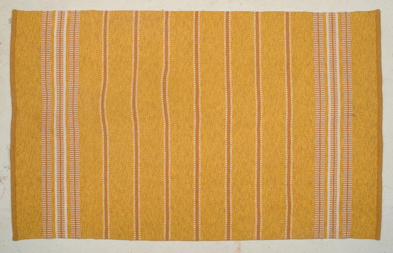 Rölakan, Sweden, large carpet in handwoven wool. Ochre yellow.
Modernist design.