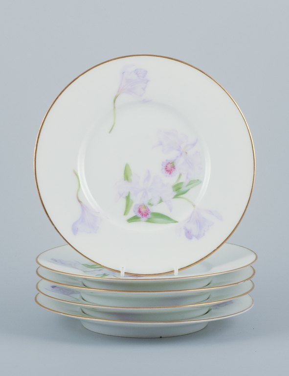 Royal Copenhagen, a set of five Art Nouveau plates hand-painted with lilies and 
gold trim. A rare collection.