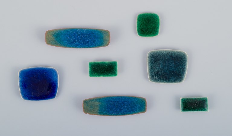 Ole Bjørn Krüger (1922-2007), Danish sculptor and ceramic artist. Seven unique 
brooches in glazed stoneware in blue and green shades.