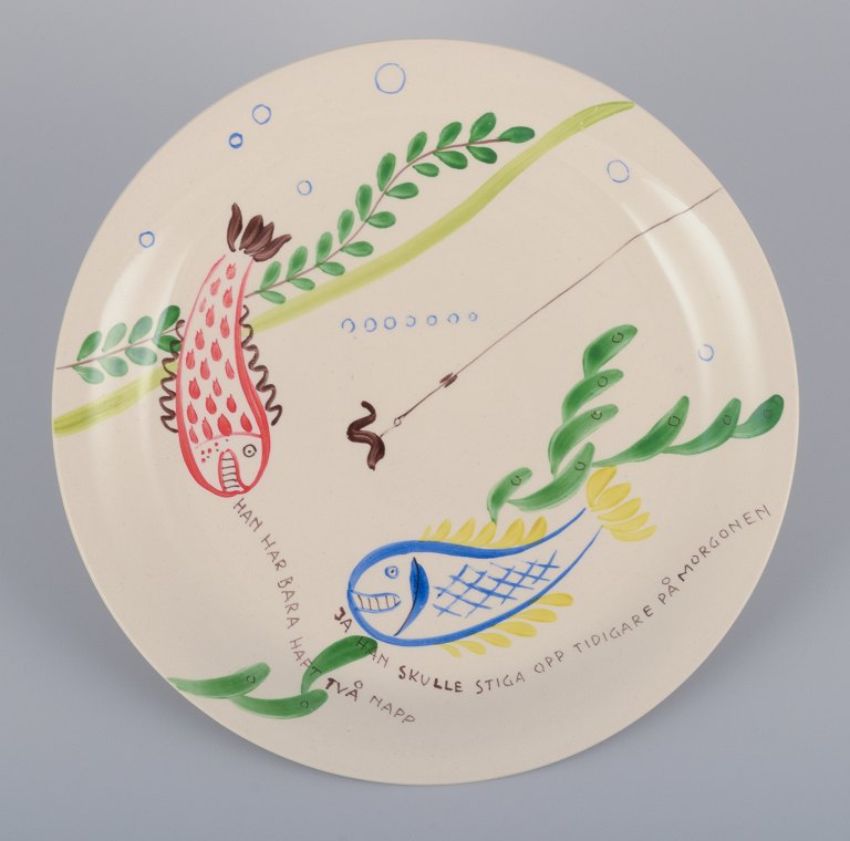 Stig Lindberg for Gustavsberg. "Löja" plate. Hand-painted with a fish motif. 
Satirical illustration with Swedish text.