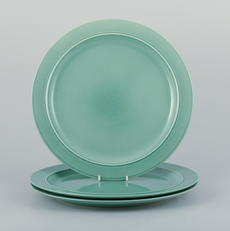 Royal Copenhagen, "4 All Seasons". A set of three dinner plates in faience with 
green glaze.