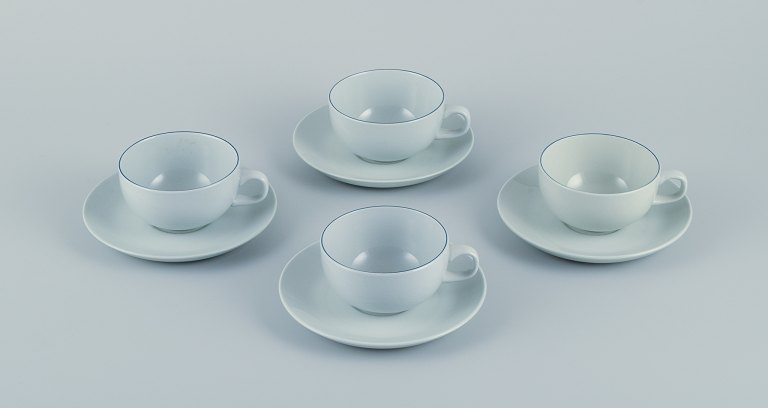 Grethe Meyer for Aluminia. A set of four Blue line coffee cups with saucers in 
faience.