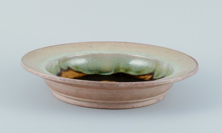 Nils Kähler for Kähler. Large ceramic bowl in modernist design.
Uranium glaze with blue and green hues.