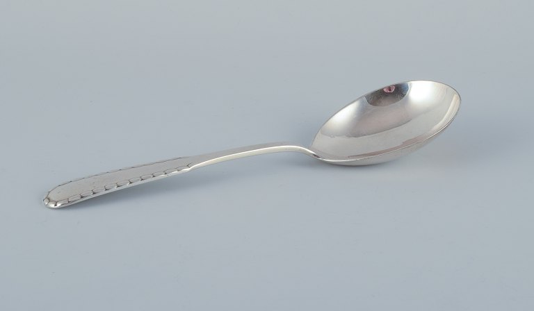 Georg Jensen "Rope" serving spoon in sterling silver.