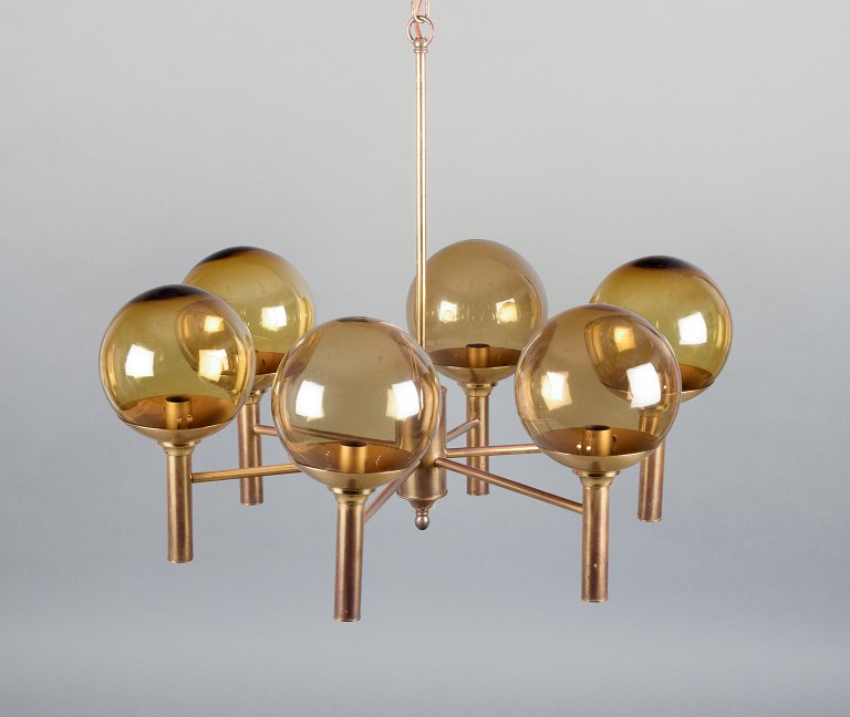 Sv. Mejlstrøm, Danish designer. Brass chandelier with six arms and dome-shaped 
shades made of amber-colored glass.