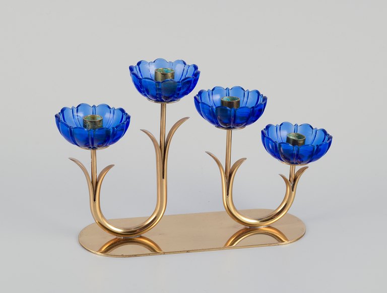 Gunnar Ander for Ystad Metall, Sweden. Candlestick holder in brass and blue art 
glass shaped like flowers. For four candles.