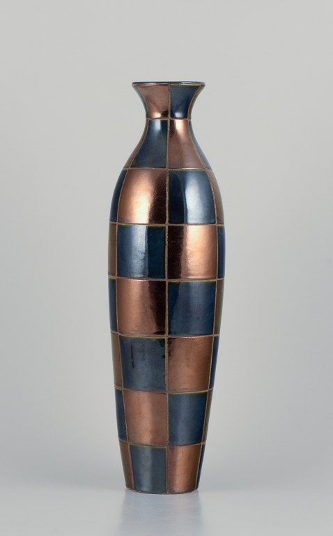 French ceramic artist. Large unique ceramic vase in a modernist design.
Square sections in blue and gold-tone glossy glaze.