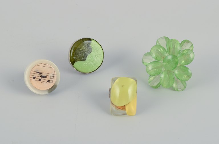 French jewelry artist. Four designer rings in metal and plastic. 
Various designs in green and yellow colors.