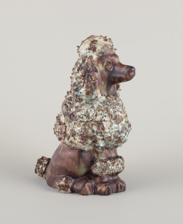 EGO Stengods, Sweden. Ceramic figure of a poodle. Glazed in brownish-green hues.