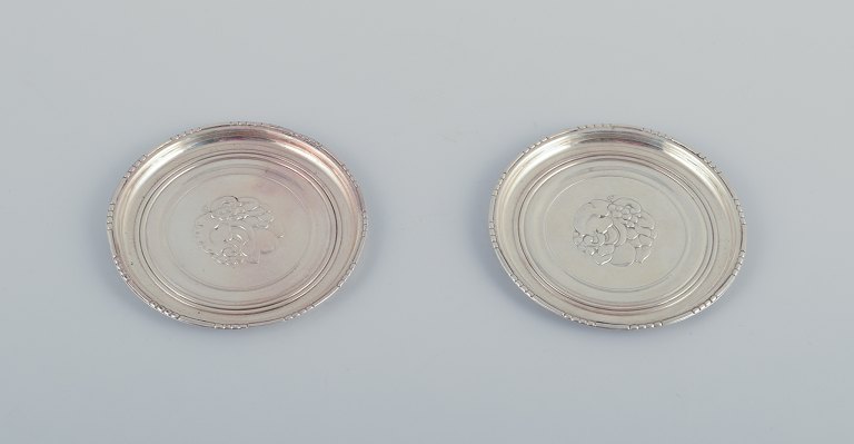 Georg Jensen, two bottle coasters in sterling silver.