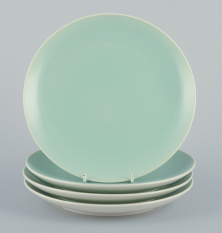 Four Aluminia "Confetti" plates in mint green glazed earthenware.