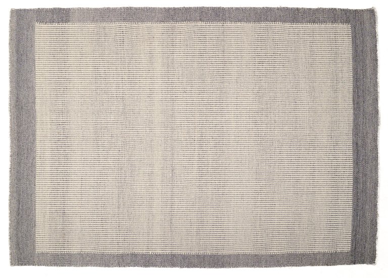 Swedish textile designer.
Hand-knotted wool rug. 
Woven in gray and white colors.