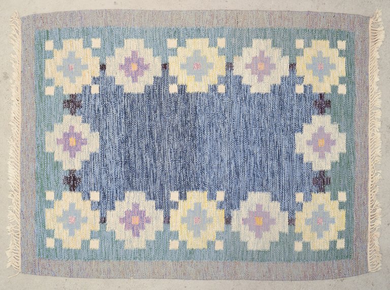 Swedish textile designer.
Handwoven rug made of wool. Rölakan technique. 
Woven with geometric patterns.