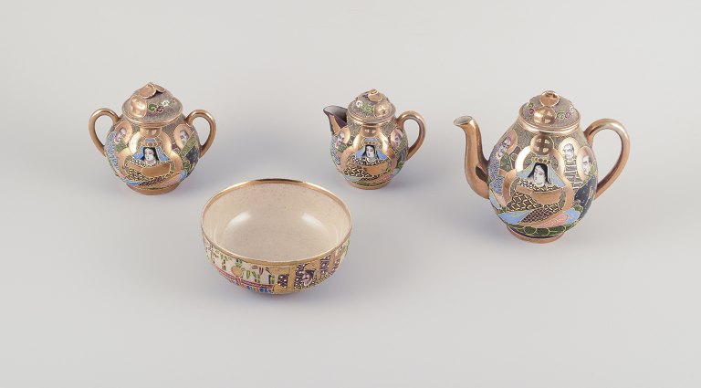Satsuma, Japan. An egoist tea set consisting of a teapot, sugar bowl, creamer, 
and cup.