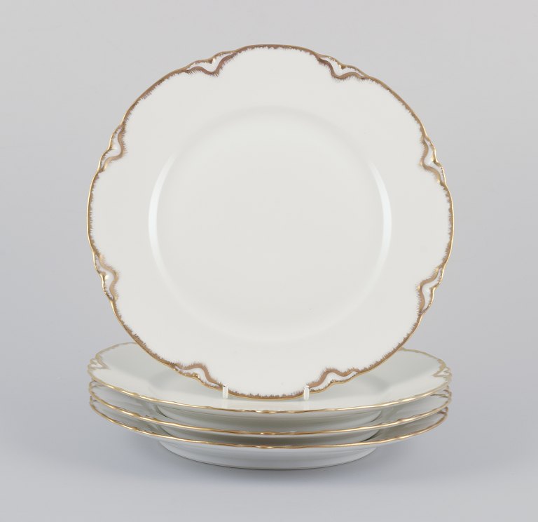 A set of four Haviland porcelain dinner plates.
Hand-decorated gold decoration, white porcelain.