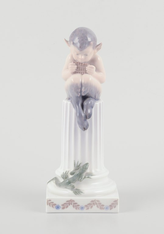 Royal Copenhagen, porcelain figurine.
Whistling Pan sitting on a pedestal with a salamander.