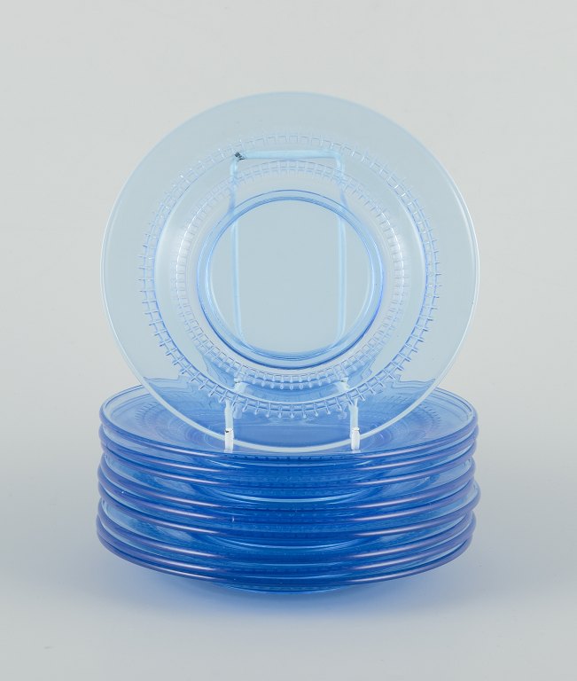 A set of ten blue glass plates.