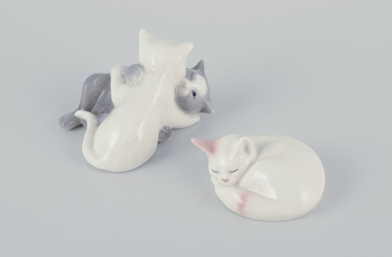 Royal Copenhagen mini collection, two porcelain figurines of sleeping kittens 
and a figurine of playing kittens.