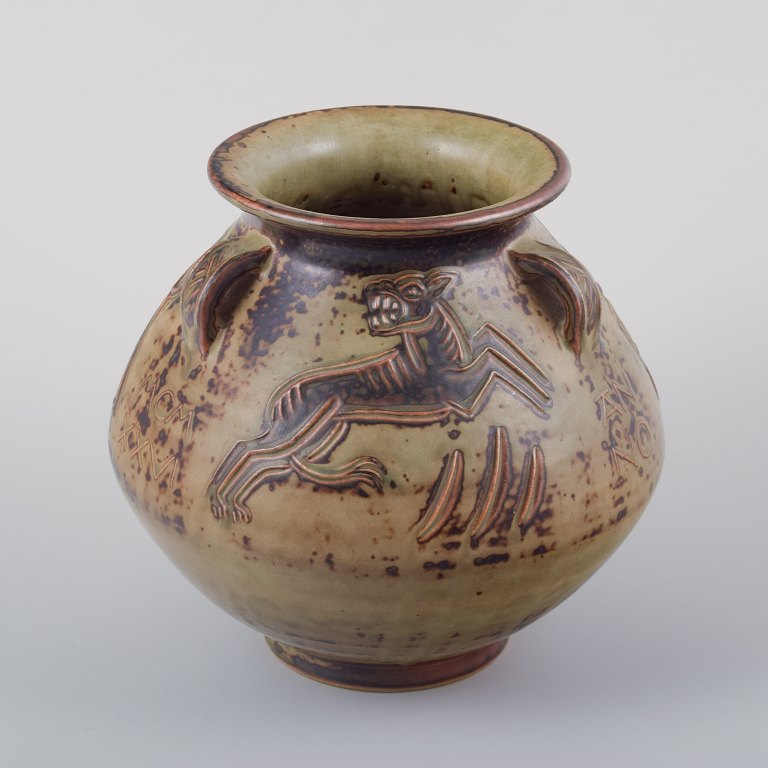 Jais Nielsen for Royal Copenhagen.
Ceramic vase in sung glaze with religious motifs.