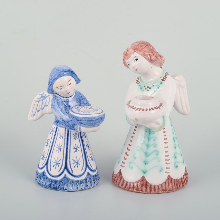 Two Hjorth ceramic candlesticks in the shape of angels, executed in glazed 
faience.