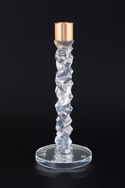 Orrefors, Sweden
Candleholder in clear crystal with faceted, sculptural shaft and brass 
candleholder.