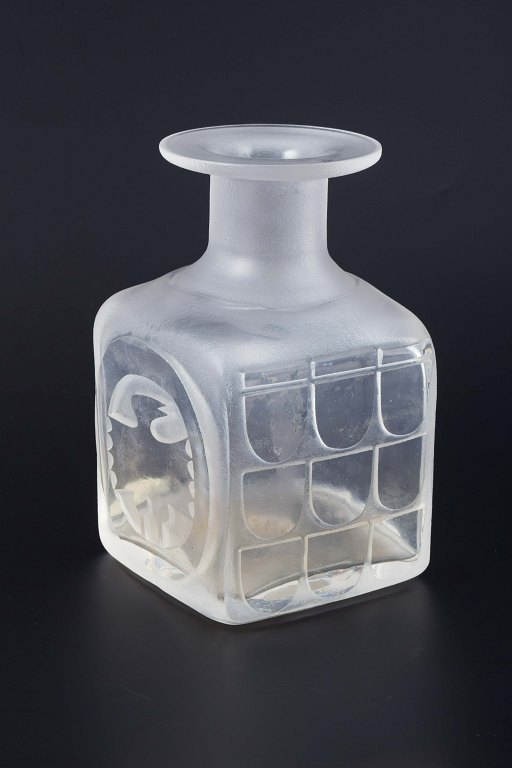 Bertil Vallien, Åfors/Kosta Boda, Sweden, ca. 1970-1980.
Square vase in frosted glass with a matte surface and relief decoration. 
Decorated with geometric panels and a stylized bird motif in relief on the 
sides.