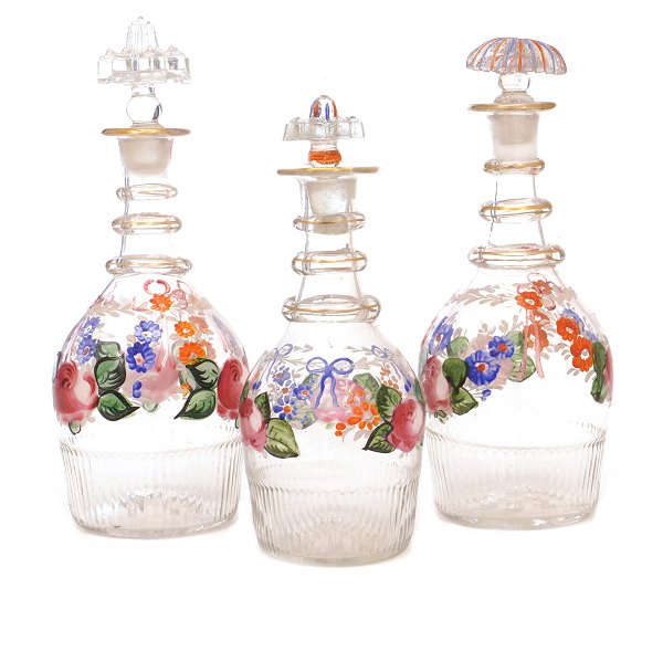 Set of three enamel decorated carafes circa 1860-80. H: 19-23cm