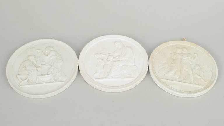 Royal Copenhagen, set of three biscuit wall plaques after Thorvaldsen.