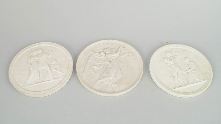 Royal Copenhagen, set of three biscuit wall plaques after Thorvaldsen.