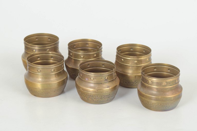 Set of six brass cups.