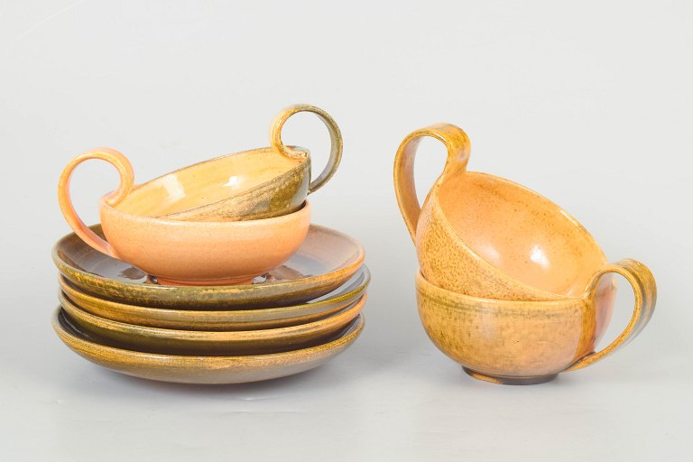 Kähler, set of four teacups with matching saucers.