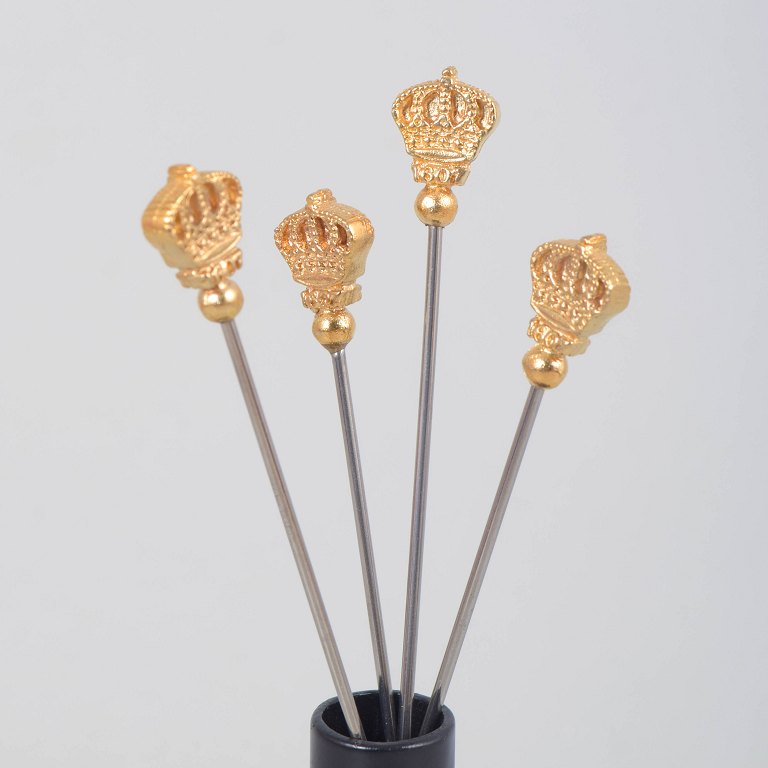 Skultuna, set of four cocktail sticks with crown motif.