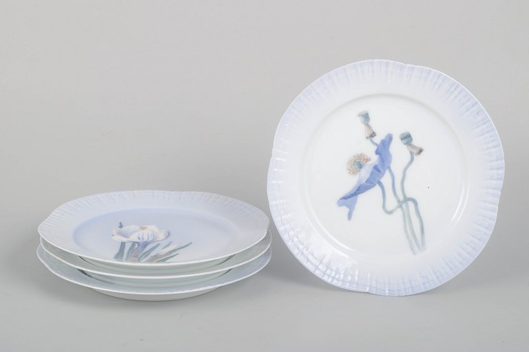 Royal Copenhagen Art Nouveau, set of four plates with floral motifs.