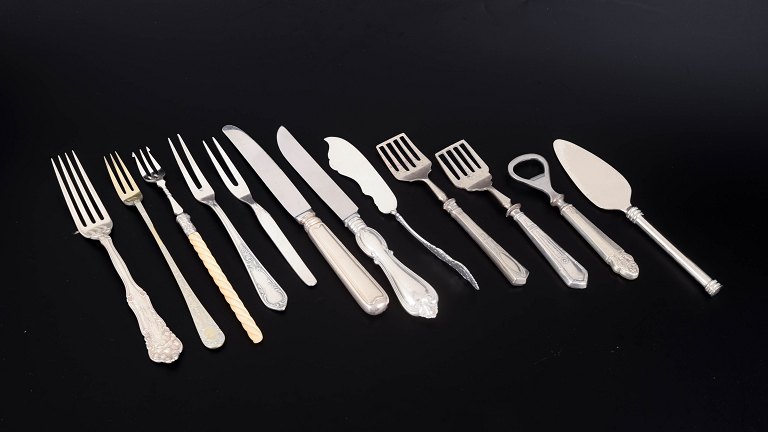 Set of twelve pieces of serving flatware by various makers.